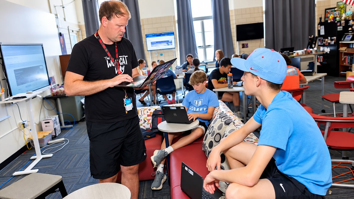 Andy Goveia works with some of his students in the newly designed classroom.