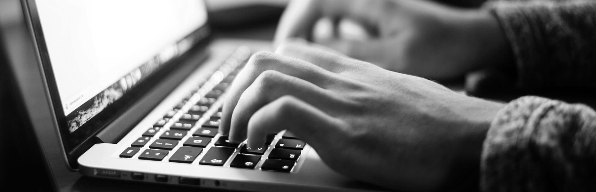 Hands typing on a keyboard